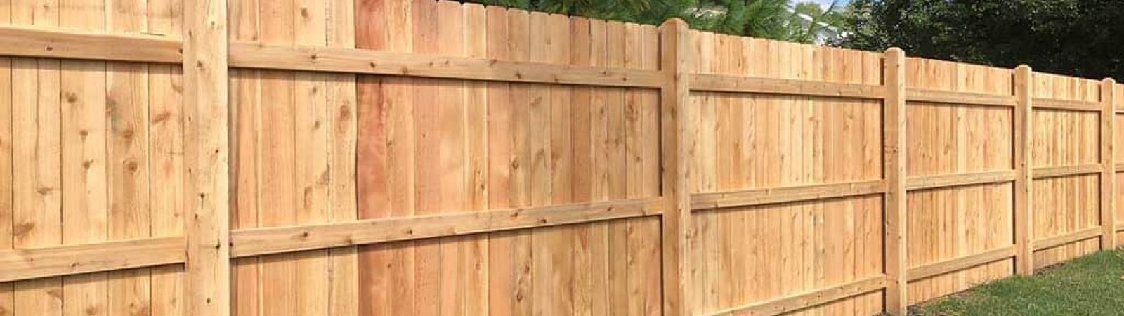 An image depicting the installation of a cedar fence.



