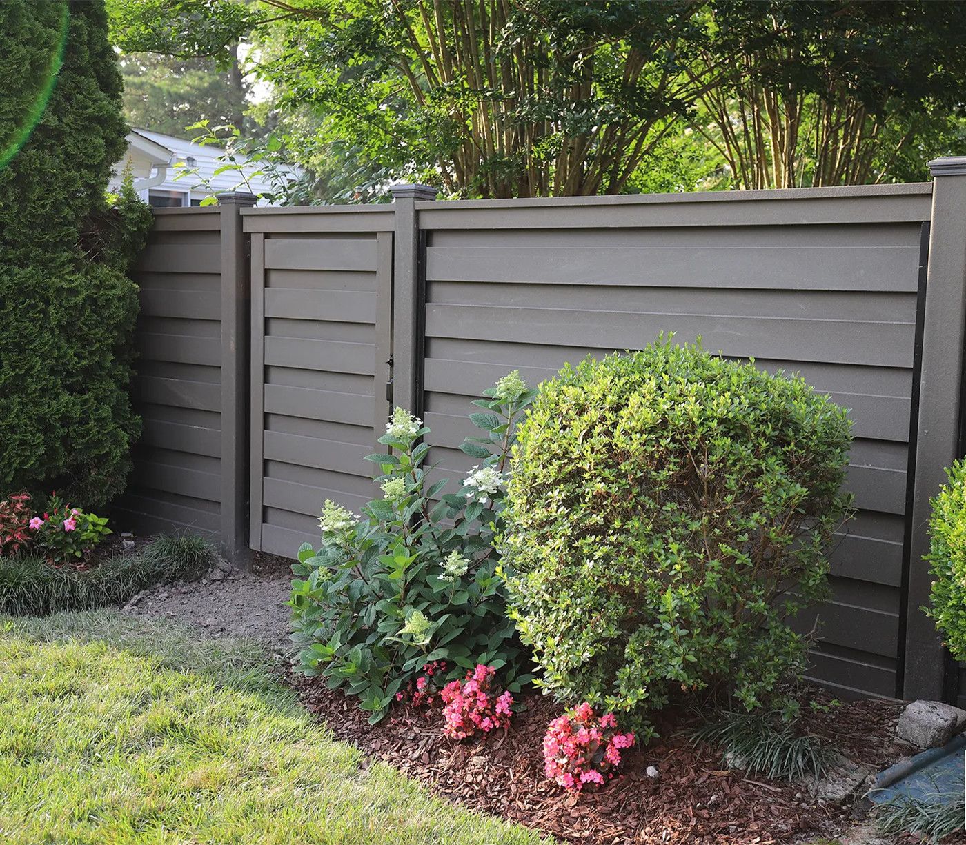 An image of a white poly picket fence