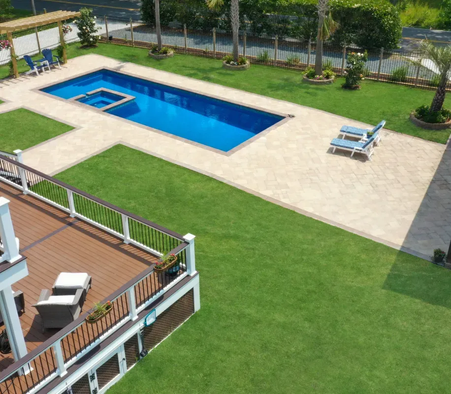 Synthetic Turf Surrounding Pool and Hardscape installed by Solid Structures.