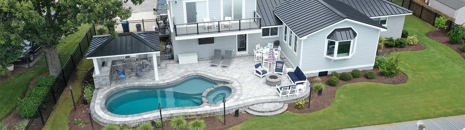 House with fiberglass pool and hardscape design