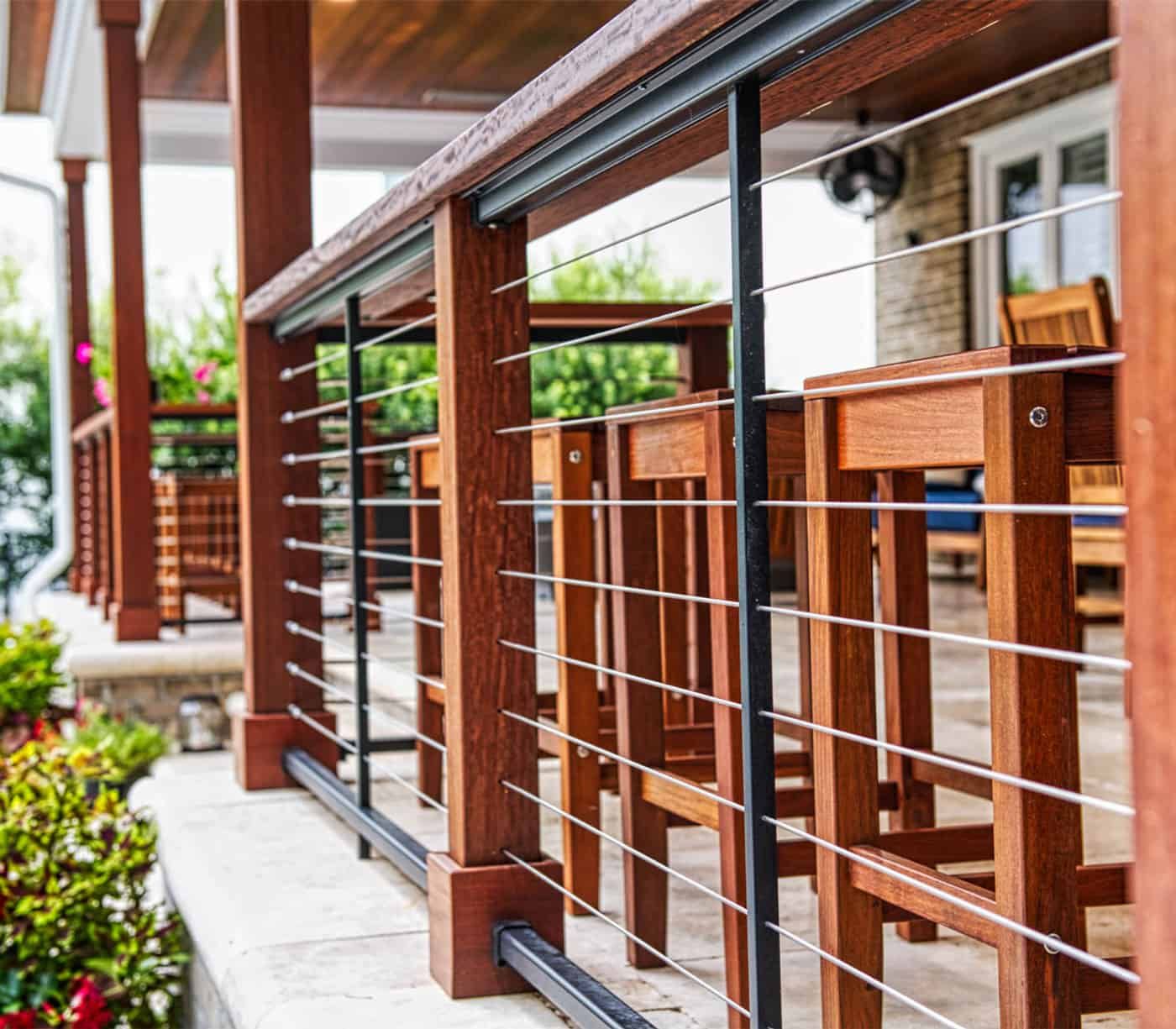 An image of a modern deck railing made of metal cables