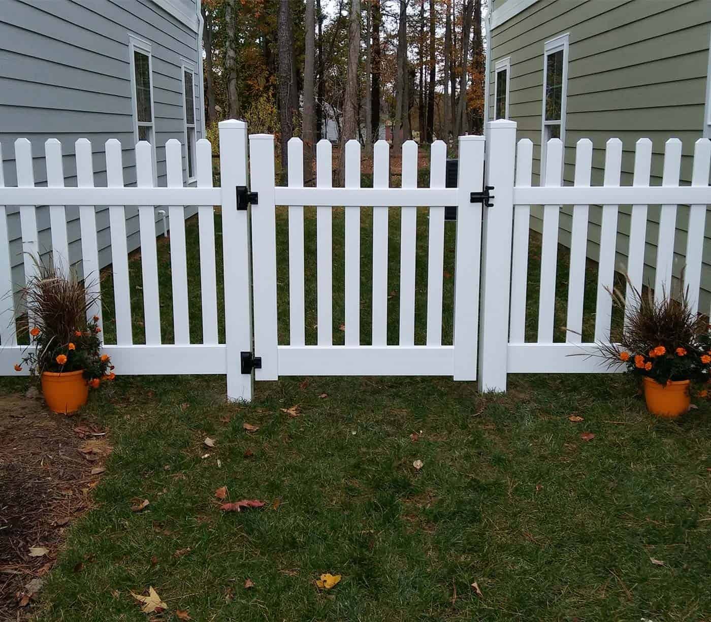 An image of a white poly picket fence