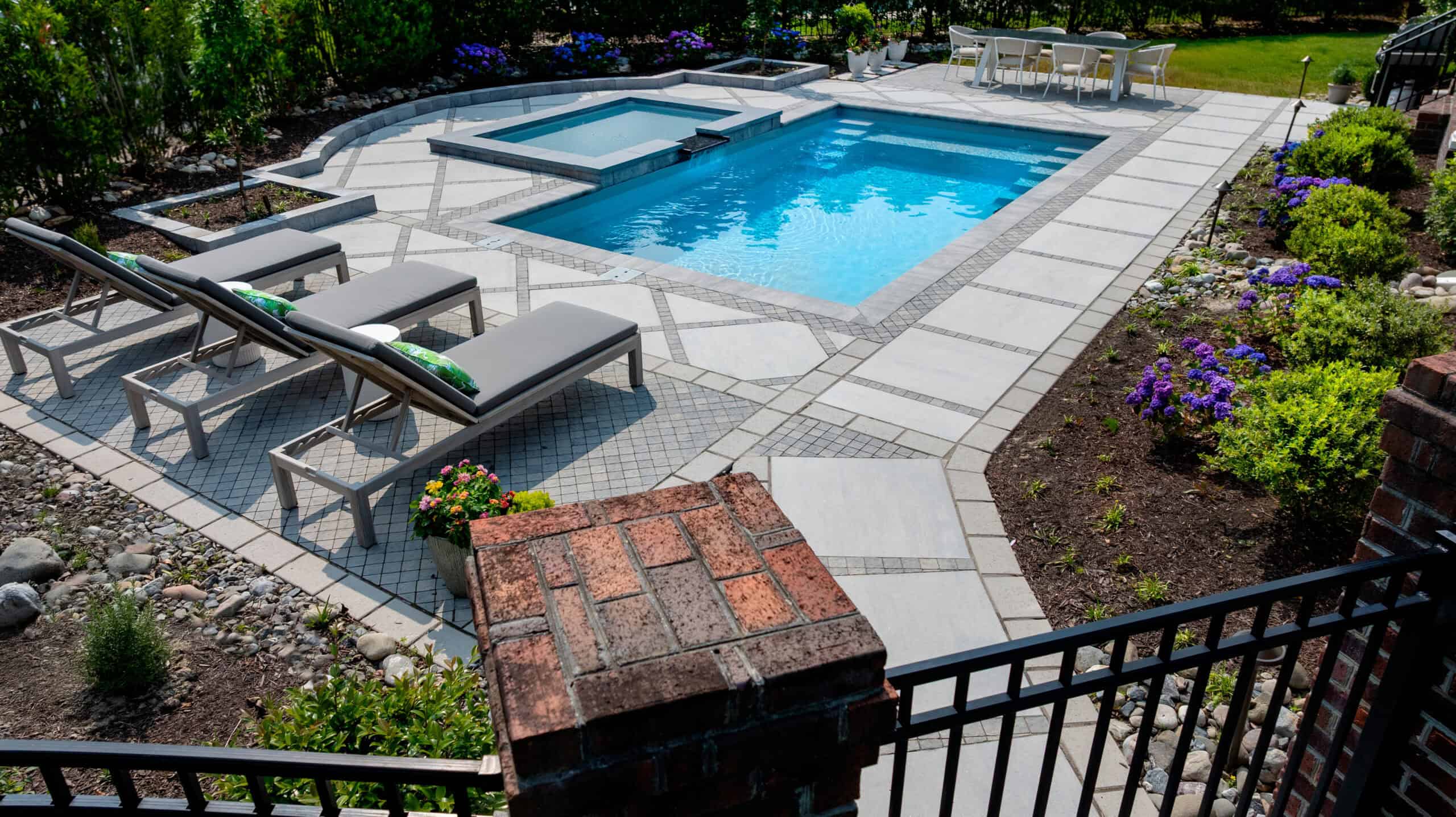 After transformation image of a backyard with swimming pool and hardscape in Virginia Beach.