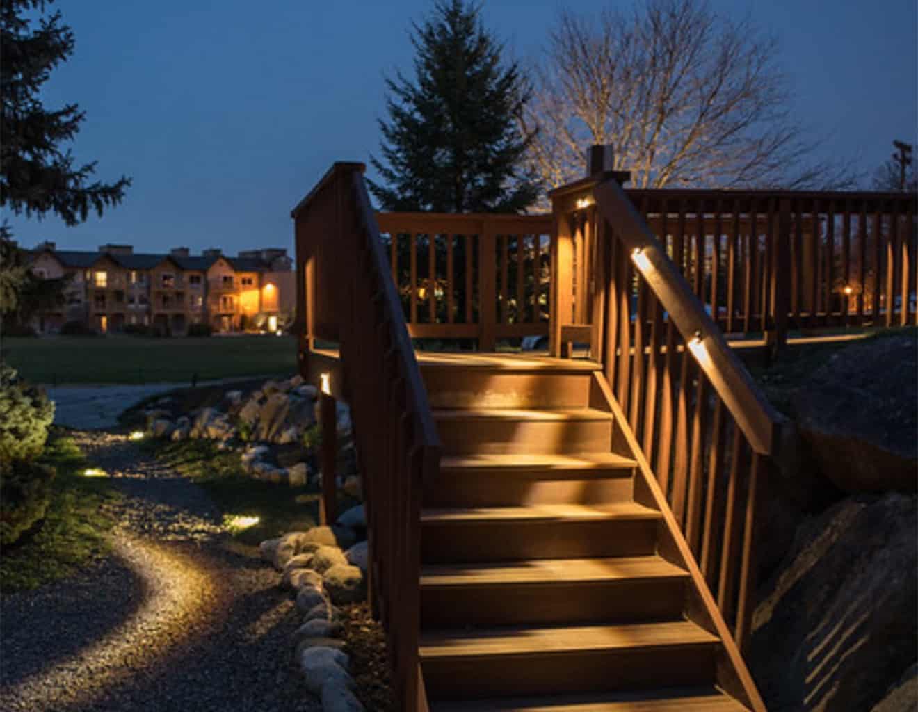 Lighting on stairs and landscape completed by solid structures.